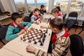 Russia, Vladivostok, 12/01/2018. Kids play chess during chess competition in chess club. Education, chess and mind games. Royalty Free Stock Photo