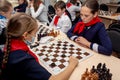 Russia, Vladivostok, 12/01/2018. Kids play chess during chess competition in chess club. Education, chess and mind games.