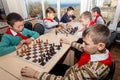 Russia, Vladivostok, 12/01/2018. Kids play chess during chess competition in chess club. Education, chess and mind games. Royalty Free Stock Photo