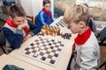 Russia, Vladivostok, 12/01/2018. Kids play chess during chess competition in chess club. Education, chess and mind games. Royalty Free Stock Photo