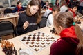 Russia, Vladivostok, 12/01/2018. Kids play chess during chess competition in chess club. Education, chess and mind games. Royalty Free Stock Photo