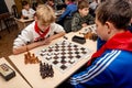 Russia, Vladivostok, 12/01/2018. Kids play chess during chess competition in chess club. Education, chess and mind games. Royalty Free Stock Photo