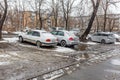 Russia, Vladivostok, March 21, 2022. Cars in a dirty parking after snow. Poor areas of city and infrastructure problems.