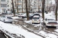 Russia, Vladivostok, March 21, 2022. Cars in a dirty parking after snow. Poor areas of city and infrastructure problems.