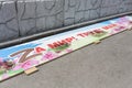 Russia, Vladivostok, May 16, 2022. Dirty banner with symbol Z on the ground. Styled inscription