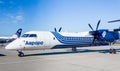 Passenger aircraft Bombardier Q400 of Aurora Airlines on airfield. Turboprop engine. Aviation and transportation