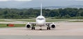 Passenger airplane SSJ 100 Sukhoi Superjet 100 of IrAero on airfield in cloudy day. Aviation and transportation