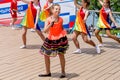 Russia, Vladivostok, 06/12/2018. Young adorable girl in colourful clothes perform song on stage. Celebration of annual Russia Day