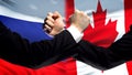 Russia vs Canada confrontation, countries disagreement, fists on flag background Royalty Free Stock Photo