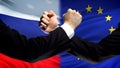 Russia vs EU confrontation, countries disagreement, fists on flag background