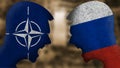 Russia vs versus Nato. Two angry faces with the flag of the country.