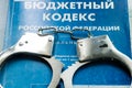 Russia. Vyborg 09.09.2021 handcuffs are on the budget code book. Inscription in Russian budget code