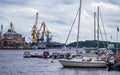 Russia, Vyborg - June 27, 2023: Yacht club on the background of the sea trade port