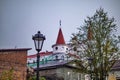 Russia, Vyborg - October 15, 2023: Vintage lantern against the background of a house with a spire in the old town