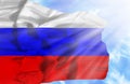 Russia waving flag against blue sky with sunrays Royalty Free Stock Photo