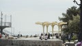 Russia, Yalta - July 16, 2019: Lot of vacationing tourists on embankment in summer. Action. Beautiful umbrellas on