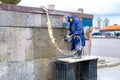Russia, Yekaterinburg, August 14, 2019 a city utility employee removes graffiti on the wall with water