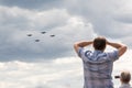 25.07.2021, Russia, Zhukovsky. Spectators look into the sky behind military aircraft fighters performing aerobatics