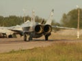 Russian aircraft Sukhoi Su-24 running on the takeoff strip. Rear jet engines view