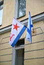 The Russian Andreevsky flag and flag of Navy of the USSR hang on a building facade