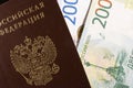 Russian banknote of two thousand and two hundred rubles with a Russian passport on a black background