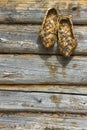 Russian bast shoes on a wooden wall Royalty Free Stock Photo
