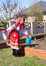 Russian beauty in the national sundress on a sunny spring day
