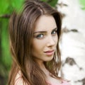 Russian beauty - Young brunette girl at a white birch Royalty Free Stock Photo