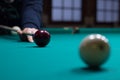 Russian billiards player aims to shoot red ball with cue Royalty Free Stock Photo