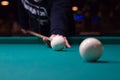 Russian billiards player aims to shoot white ball with cue Royalty Free Stock Photo
