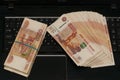 Russian bills are on the laptop keyboard Royalty Free Stock Photo