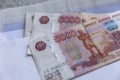 Russian bills of various denominations lie on an envelope on the table. Close-up Royalty Free Stock Photo