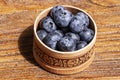 Russian birch tree bark bowl of fresh blueberries on rustic wooden table. Healthy organic seasonal fruit background Royalty Free Stock Photo