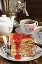 Russian bliny with raspberry jam, vintage samovar and teaware Royalty Free Stock Photo