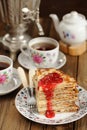 Russian bliny with raspberry jam, vintage samovar and teaware Royalty Free Stock Photo