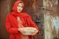 Russian blonde with blue eyes in a red kerchief is working on the farm. The concept of female beauty and perfection Royalty Free Stock Photo