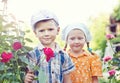 Russian boy and girl at roses Royalty Free Stock Photo