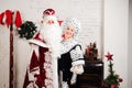 Russian Christmas characters: Ded Moroz, Santa and Snegurochka, snow girl posing in the studio Royalty Free Stock Photo