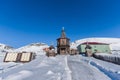 Russian city of Barentsburg on the Spitsbergen archipelago in the winter in the Arctic In sunny weather and blue sky