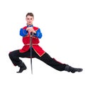 Russian cossack dance. Young dancer posing with sword