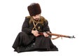 Russian Cossack inspecting a rifle.