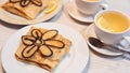 Russian crepes decorated with baked flower and tea