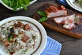 Russian cuisine: closeup beef meat stewed with vegetables in ceramic pot on wooden background Royalty Free Stock Photo