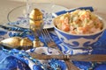 Russian cuisine: salad Olivier in blue bowl in gzhel style Royalty Free Stock Photo