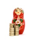 Russian Doll and Piles of Coins Royalty Free Stock Photo