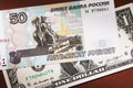 Russian fifty rubles and one dollar on the table. The concept of strengthening the ruble