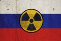 Russian flag on wall and radioactive symbol. Concept of nuclear weapons