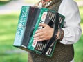 Russian folk instrument - accordion, harmonica in hands of musician