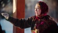 Russian folklore - Russian woman smiling standing outdoors and pointing at something