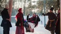 Russian folklore - young woman swinging and everyone is laughing on a sunny day